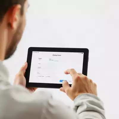 User submitting online form on tablet