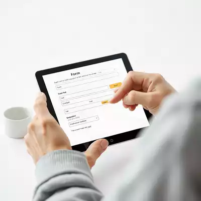 User submitting online form on tablet